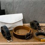 Belts Fashion - Assorted Black Leather Belts on Brown Wood Table
