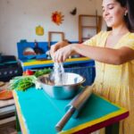 Mixing Prints - Woman in Yellow Dress Mixing Flour in Stainless Steel Bowl