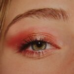 Dewy Makeup - woman with pink and gold eyeshadow makeup