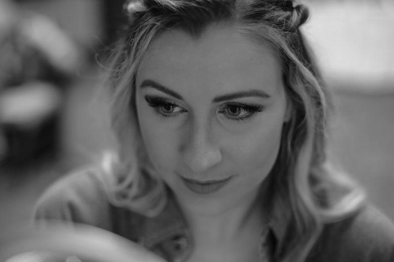 Smoky Eye - grayscale photo of woman smiling