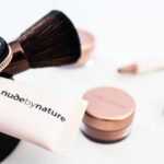 Makeup Primer - Nude by Nature soft-tube beside brown makeup brush