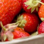 Healthy Scalp - A box of strawberries on a wooden table