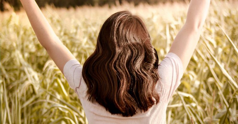 Hair Growth - Woman on Grass Field Lifting Hands