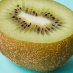 Vitamins Hair - Cut juicy kiwi on blue surface