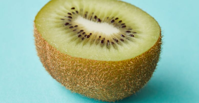 Vitamins Hair - Cut juicy kiwi on blue surface