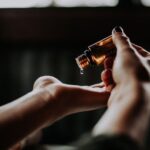 Natural Oils - person holding amber glass bottle