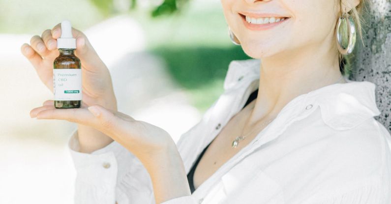 Green Tea Skincare - Smiling Woman in White Dress Shirt Holding Black Smartphone