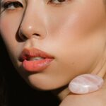 Mineral Makeup - Asian female with stylish makeup and stone on shoulder