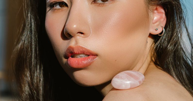 Mineral Makeup - Asian female with stylish makeup and stone on shoulder