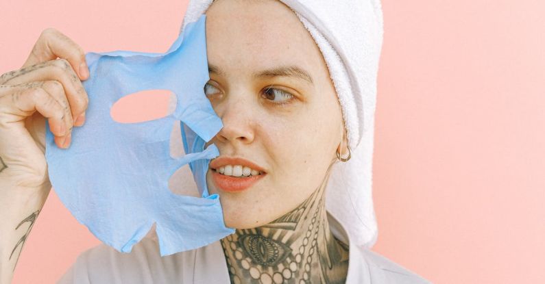 Tattoo Removal - Young woman in towel on head removing mask from face